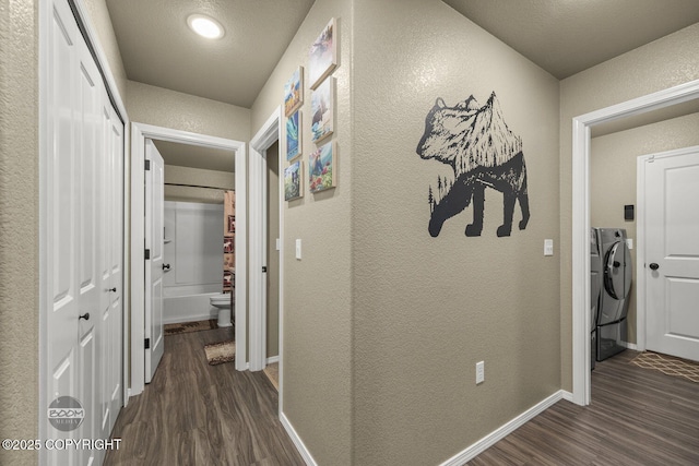 hall with washer / dryer and dark wood-type flooring