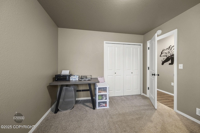 office area with carpet flooring and a textured ceiling