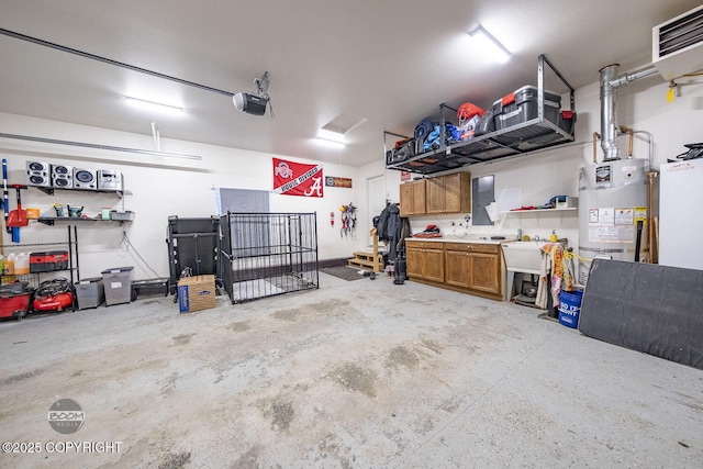 garage featuring a garage door opener and strapped water heater