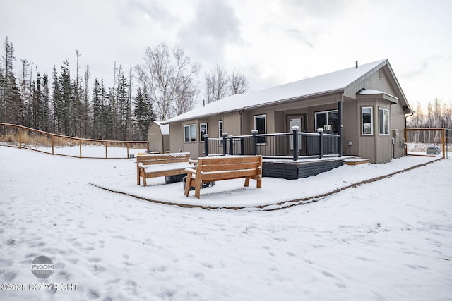 view of snow covered back of property