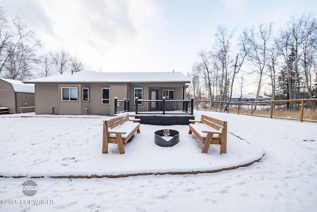 snow covered house featuring an outdoor fire pit