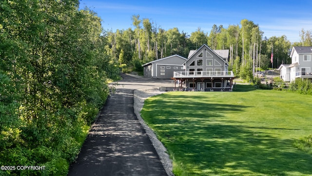 rear view of house featuring a lawn