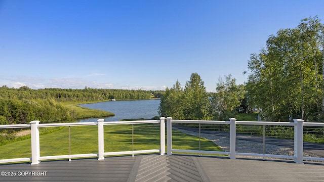 wooden deck featuring a yard and a water view