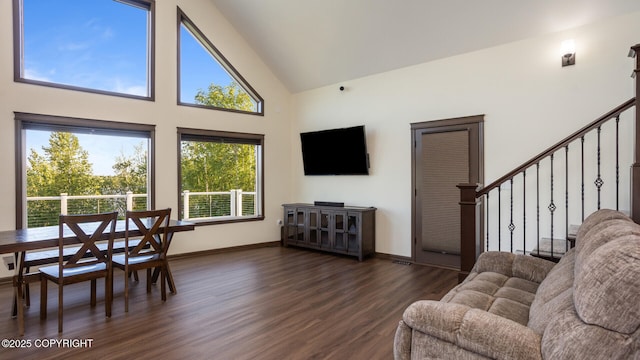 living room with dark hardwood / wood-style floors and high vaulted ceiling