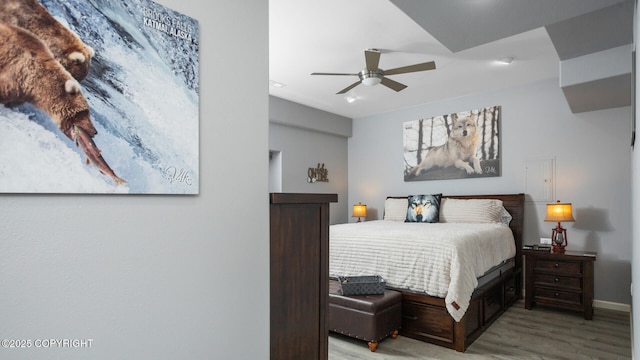 bedroom featuring ceiling fan and light hardwood / wood-style floors