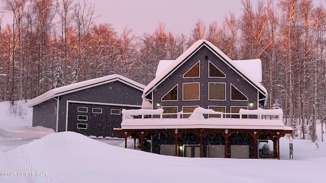 view of snow covered back of property