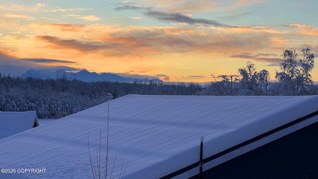 yard at dusk featuring a mountain view