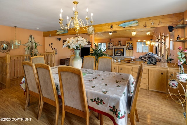 dining space featuring a notable chandelier and light hardwood / wood-style floors