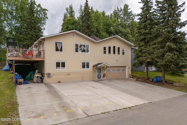 front facade with a wooden deck and a garage