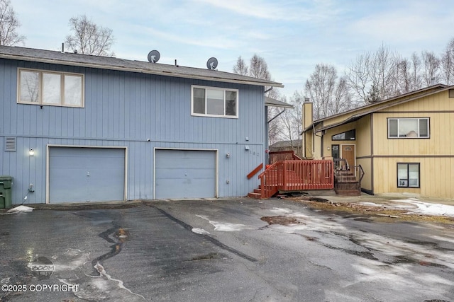 exterior space with a garage and a deck