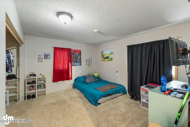 bedroom with carpet and a textured ceiling