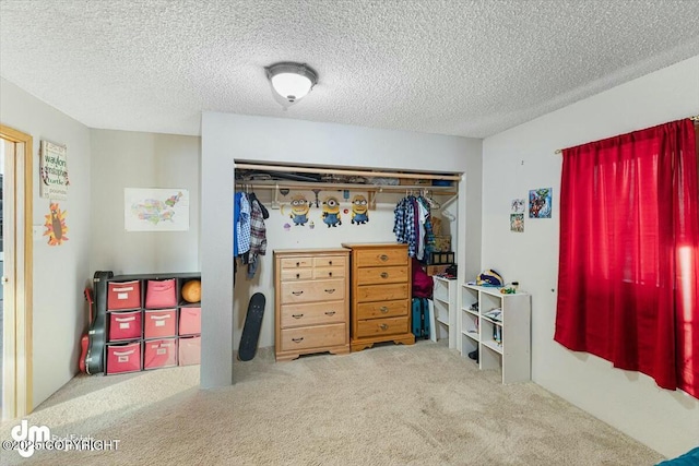 interior space featuring carpet, a textured ceiling, and a closet