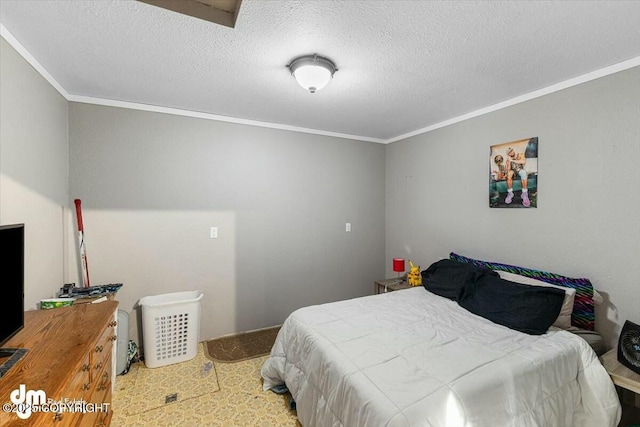 bedroom featuring ornamental molding and a textured ceiling