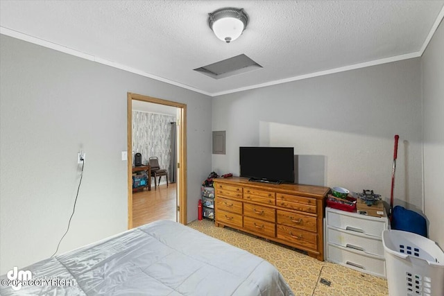 bedroom featuring crown molding and a textured ceiling