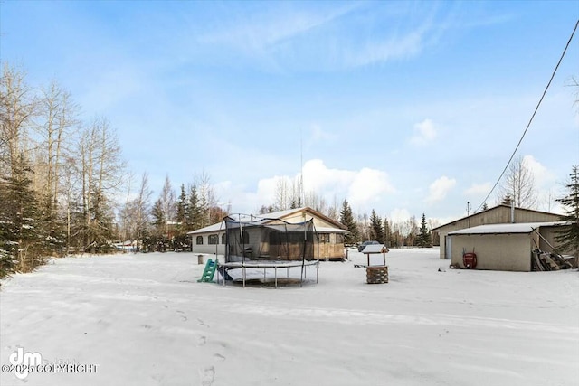 snow covered property with a trampoline