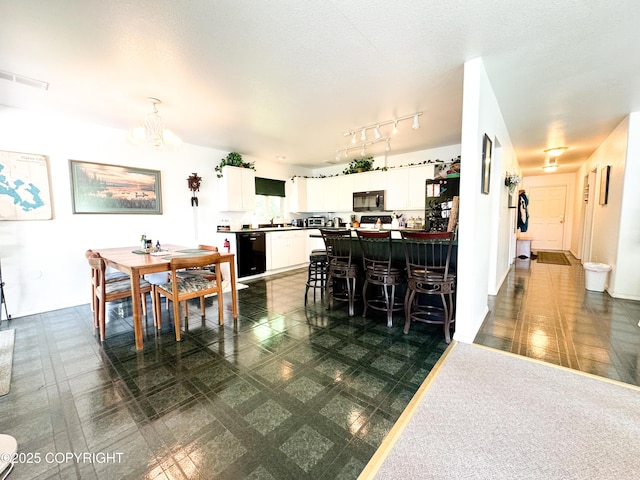 9218 N Erica Dr, Willow, AK 99688 - dining area featuring a chandelier and dark flooring