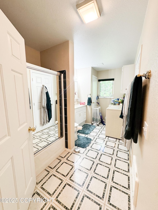 9218 N Erica Dr, Willow, AK 99688 - bathroom with washer / clothes dryer, a textured ceiling, shower / washtub combination, and vanity