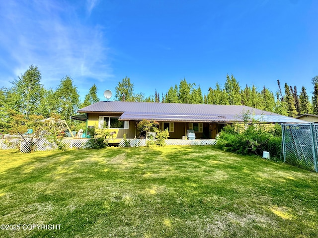 9218 N Erica Dr, Willow, AK 99688 - back of property featuring a yard, covered porch, and a metal roof