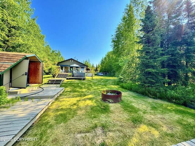 9218 N Erica Dr, Willow, AK 99688 - view of green lawn with a deck and a storage shed