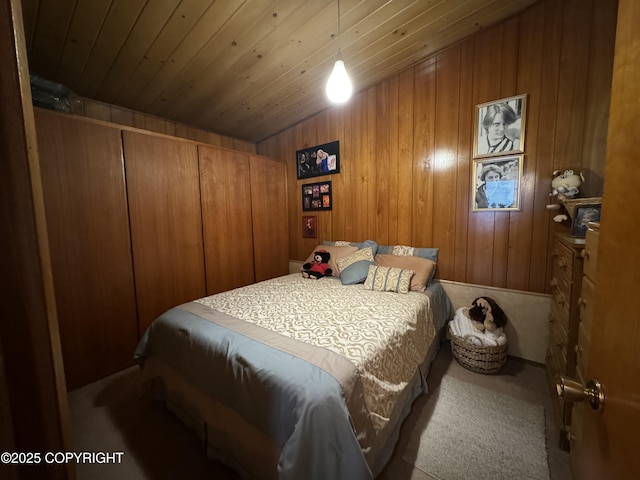 bedroom featuring carpet, wooden ceiling, and wooden walls