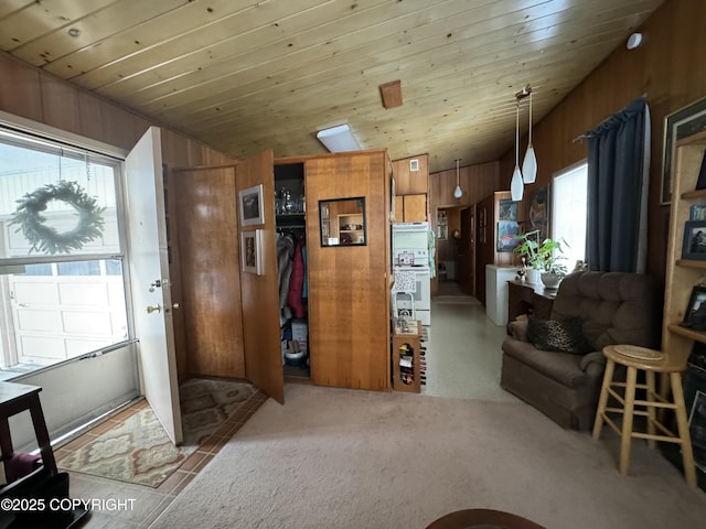 interior space featuring wood ceiling and wood walls