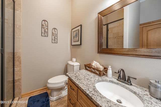 bathroom featuring vanity, toilet, and a shower with door