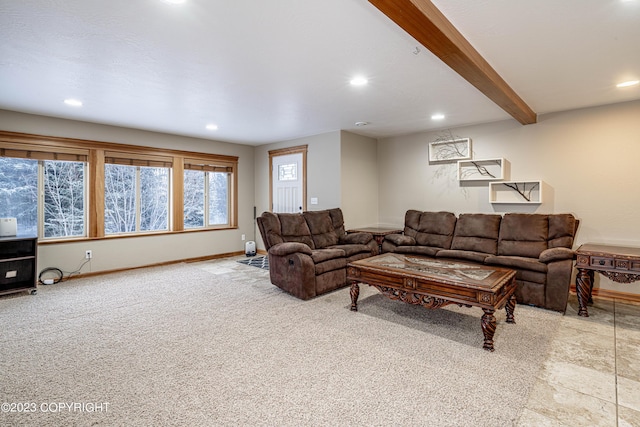 carpeted living room with beam ceiling