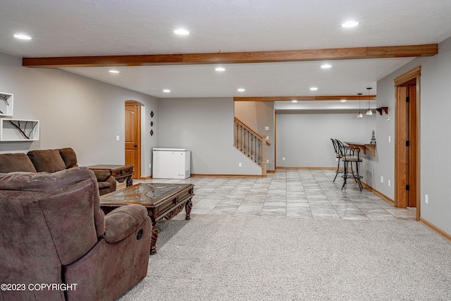 living room featuring light carpet, a textured ceiling, and beam ceiling