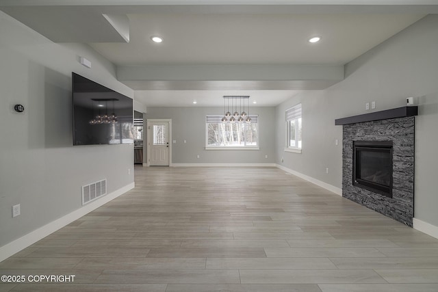 unfurnished living room featuring a fireplace and light hardwood / wood-style flooring