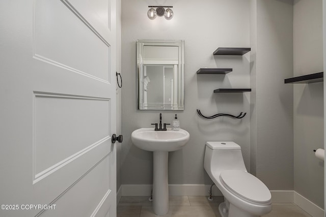 bathroom featuring tile patterned floors and toilet