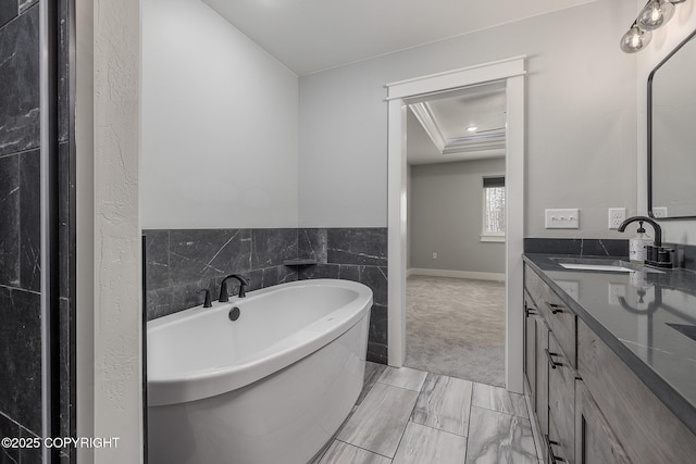 bathroom featuring vanity, a bathtub, and tile walls