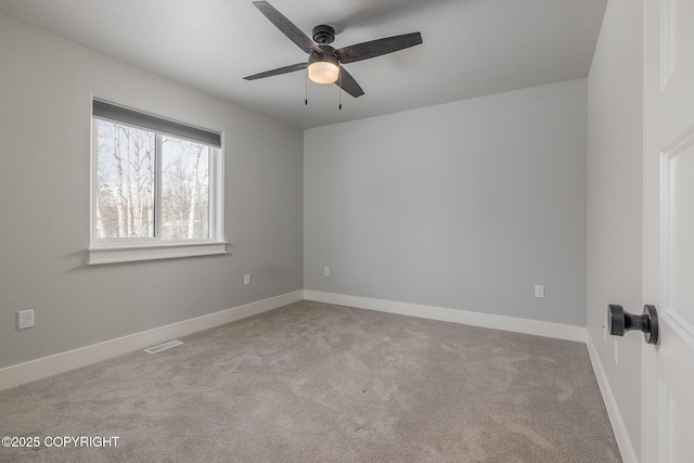 unfurnished room featuring light colored carpet and ceiling fan