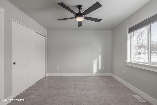 unfurnished bedroom with light carpet and ceiling fan