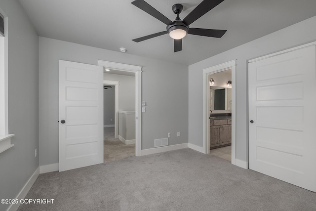 unfurnished bedroom with light carpet, ensuite bath, and ceiling fan