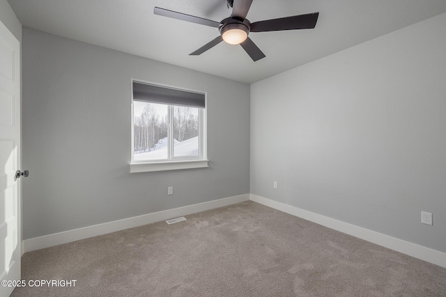 carpeted spare room with ceiling fan