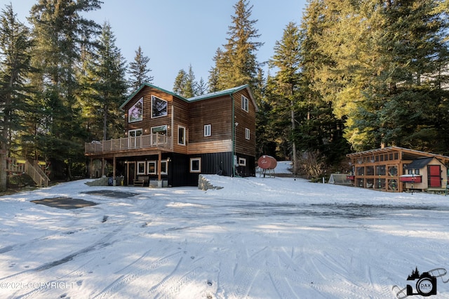 snow covered house with a deck