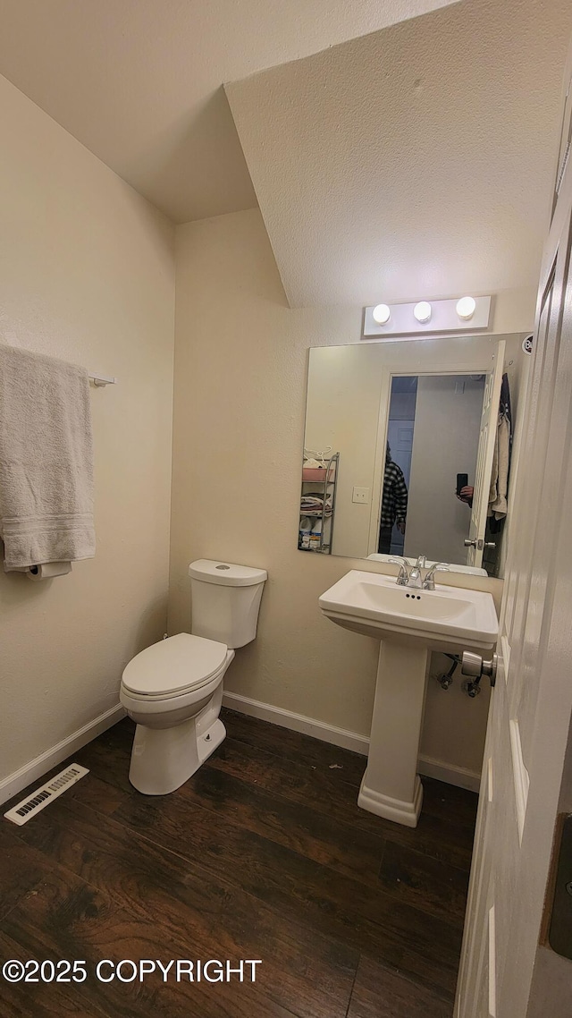 bathroom featuring sink, toilet, and hardwood / wood-style floors