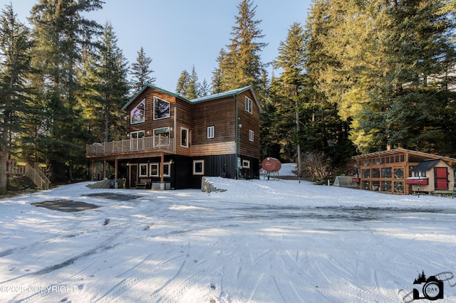 snow covered property featuring a deck