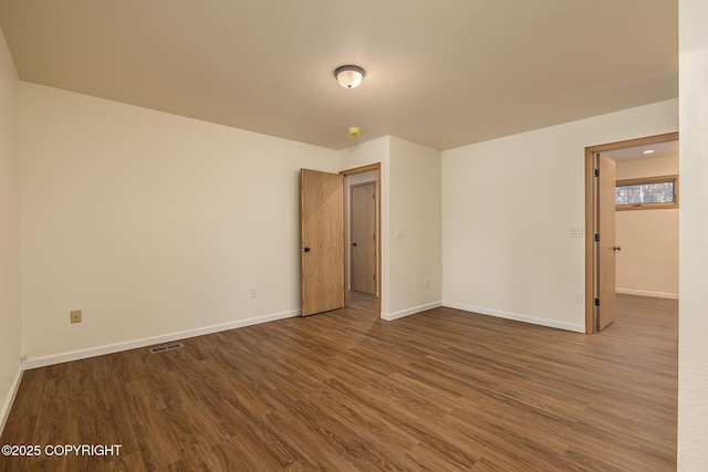 spare room with wood-type flooring