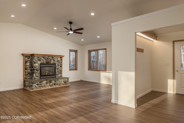 unfurnished living room featuring a fireplace, lofted ceiling, and dark hardwood / wood-style flooring