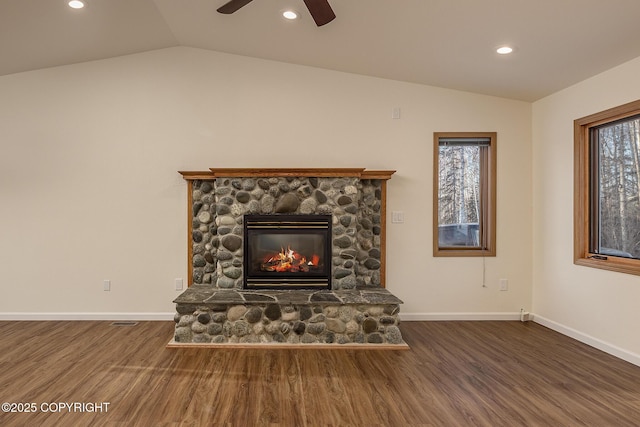 unfurnished living room featuring dark wood-type flooring, a fireplace, and vaulted ceiling