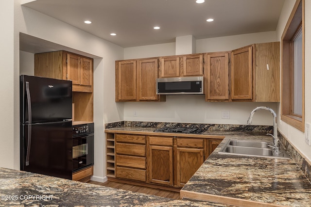 kitchen with dark wood-type flooring, sink, and black appliances