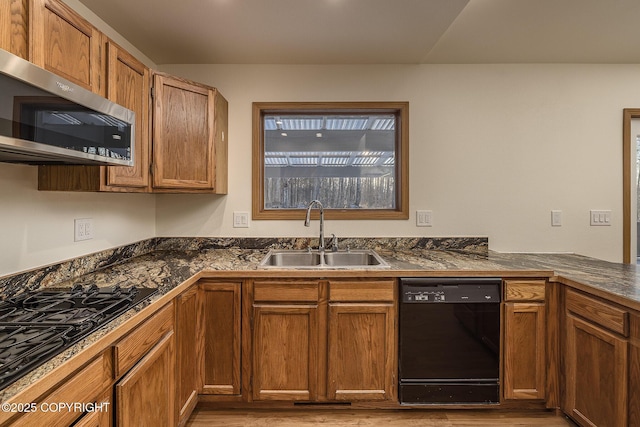 kitchen with light wood-type flooring, sink, and black appliances