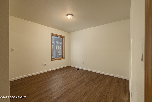 unfurnished room featuring dark hardwood / wood-style flooring