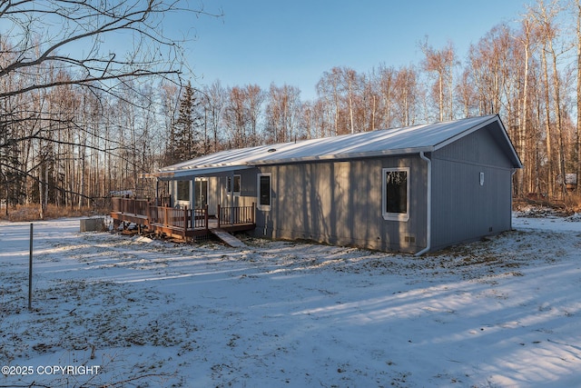 snow covered property featuring a deck