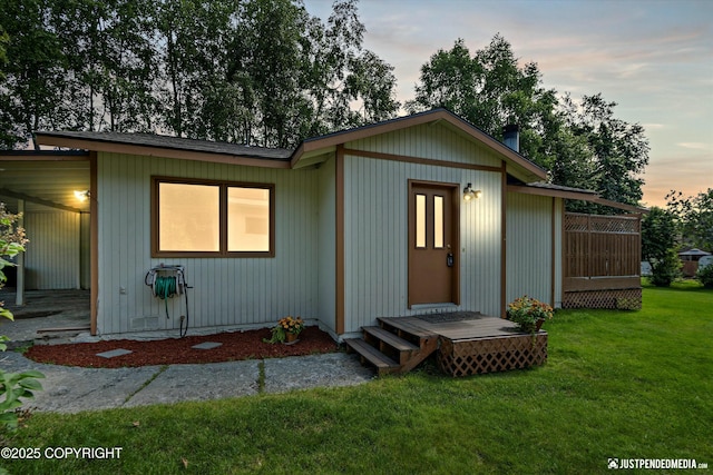 back house at dusk with a yard