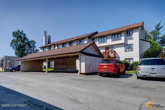 7750 Boundary Ave # A3, Anchorage, AK 99504 - view of property featuring covered and uncovered parking