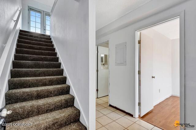 7750 Boundary Ave # A3, Anchorage, AK 99504 - stairs featuring electric panel and tile patterned flooring