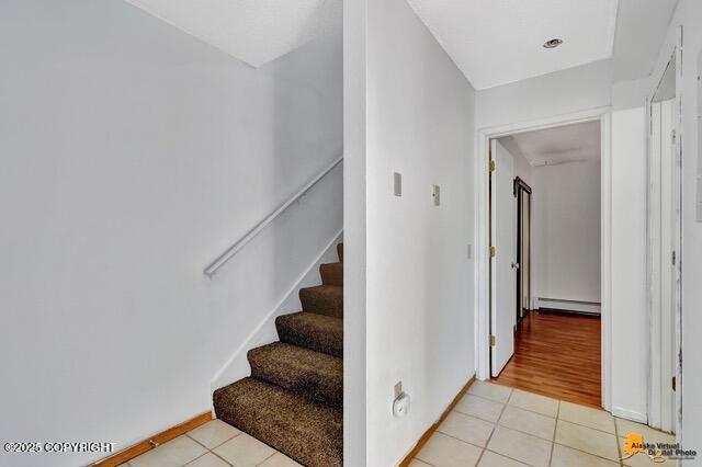 7750 Boundary Ave # A3, Anchorage, AK 99504 - stairs featuring a baseboard radiator and tile patterned flooring