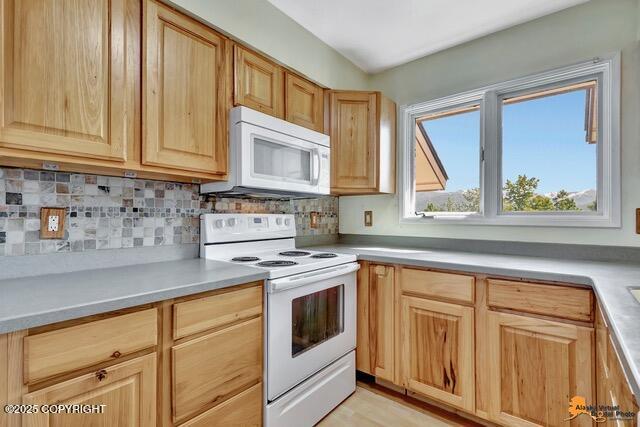 7750 Boundary Ave # A3, Anchorage, AK 99504 - kitchen with white appliances, light brown cabinets, and light countertops